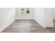 This bedroom features stylish wood floors, a bright window, and neutral paint at 7638 Sw 60Th St, Ocala, FL 34474