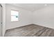 Well-lit bedroom featuring sleek wood-look flooring and a window offering plenty of natural light at 7638 Sw 60Th St, Ocala, FL 34474