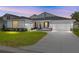 Charming single-Gathering home with a well-manicured lawn, a two-car garage, and stone column accents at 7638 Sw 60Th St, Ocala, FL 34474