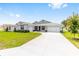 Inviting single-Gathering home with a lush lawn, a two-car garage, and a spacious concrete driveway at 7638 Sw 60Th St, Ocala, FL 34474