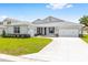 Well-maintained single-story home with a bright green lawn, stone accents, and a two-car garage at 7638 Sw 60Th St, Ocala, FL 34474