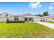 Well-maintained single-story home with a bright green lawn, stone accents, and a two-car garage at 7638 Sw 60Th St, Ocala, FL 34474