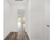 Bright hallway with wood-look flooring leading to an open living area and ample natural light at 7638 Sw 60Th St, Ocala, FL 34474