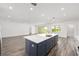 Bright, open kitchen features a large island, stainless steel appliances, and sliding glass doors for ample natural light at 7638 Sw 60Th St, Ocala, FL 34474