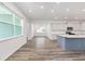 Bright, open kitchen with large windows and an island with a sink at 7638 Sw 60Th St, Ocala, FL 34474