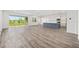 Open living space with hardwood floors, large sliding glass doors and a modern kitchen at 7638 Sw 60Th St, Ocala, FL 34474