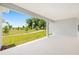 Spacious covered patio with views of the lush green backyard, trees, and walking path at 7638 Sw 60Th St, Ocala, FL 34474