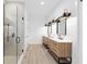 Modern bathroom with a glass-enclosed shower and double vanity with stylish lighting at 8200 Sw 125Th Court Rd, Dunnellon, FL 34432