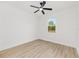 Cozy bedroom featuring wood-look flooring, ceiling fan, and a window providing natural light at 8200 Sw 125Th Court Rd, Dunnellon, FL 34432