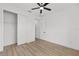 Bright bedroom features wood-look floors, a ceiling fan, and closet for ample storage at 8200 Sw 125Th Court Rd, Dunnellon, FL 34432