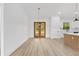 Open dining area featuring wood-look floors, stylish lighting, and exterior access at 8200 Sw 125Th Court Rd, Dunnellon, FL 34432