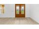 Inviting entryway featuring decorative glass double doors and durable, light-colored wood-look flooring at 8200 Sw 125Th Court Rd, Dunnellon, FL 34432