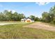 Single-story home with a well-kept lawn, long driveway, and a charming covered front porch at 8200 Sw 125Th Court Rd, Dunnellon, FL 34432