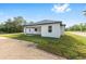 A side view of a single-story home with a covered patio and green lawn at 8200 Sw 125Th Court Rd, Dunnellon, FL 34432
