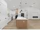 Modern kitchen with stainless steel appliances, a large island with quartz countertops, and stylish pendant lighting at 8200 Sw 125Th Court Rd, Dunnellon, FL 34432