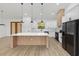 Modern kitchen featuring a large island with quartz countertop, stainless steel appliances, and white cabinetry at 8200 Sw 125Th Court Rd, Dunnellon, FL 34432