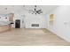 Bright open living space featuring a ceiling fan and fireplace adjoining the kitchen area at 8200 Sw 125Th Court Rd, Dunnellon, FL 34432