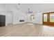 Bright, open living space with fireplace, fan, and front door with decorative glass at 8200 Sw 125Th Court Rd, Dunnellon, FL 34432