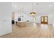 Bright and airy living space connects to the kitchen, featuring stylish pendant lighting and front door at 8200 Sw 125Th Court Rd, Dunnellon, FL 34432