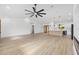 Spacious living room area featuring an open floor plan, a ceiling fan, and wood-look flooring at 8200 Sw 125Th Court Rd, Dunnellon, FL 34432