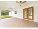 Covered patio featuring ceiling fans and access to a spacious backyard at 8200 Sw 125Th Court Rd, Dunnellon, FL 34432