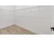 Empty walk-in closet featuring white walls, a shelf and wood-look flooring at 8200 Sw 125Th Court Rd, Dunnellon, FL 34432