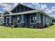 Beautiful exterior of a modern home featuring manicured lawn and stylish stone accents on the columns at 8290 Nw 17Th Cir, Ocala, FL 34475