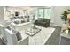 Inviting living room showcasing an open floor plan with a modern kitchen in the background at 8290 Nw 17Th Cir, Ocala, FL 34475