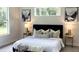 Serene main bedroom featuring a plush bed, stylish decor, and abundant natural light from the windows at 8290 Nw 17Th Cir, Ocala, FL 34475