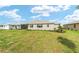 Beautiful backyard with a well-manicured lawn, young trees, and view of the house at 8465 Sw 101St Ave, Ocala, FL 34481