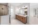 Bathroom featuring double vanity, walk-in shower with glass door, and modern fixtures at 8465 Sw 101St Ave, Ocala, FL 34481