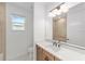 Bathroom showcasing a large mirror, tiled walls, modern fixtures, and ample lighting at 8465 Sw 101St Ave, Ocala, FL 34481