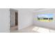 Bright bedroom with neutral tones, tile flooring, and a view of the neighborhood at 8465 Sw 101St Ave, Ocala, FL 34481