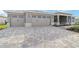 Expansive stone driveway leading to an attached two car garage door on an attractive house at 8465 Sw 101St Ave, Ocala, FL 34481