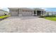 Long driveway features an attractive stone-paved design leading up to the home's attached two car garage at 8465 Sw 101St Ave, Ocala, FL 34481
