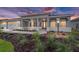 Beautiful single-story home featuring a well-manicured lawn, elegant landscaping, and a covered front entry at 8465 Sw 101St Ave, Ocala, FL 34481