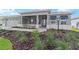 Home with well-maintained landscaping, a stone-paved walkway, and covered entry with overhead lighting at 8465 Sw 101St Ave, Ocala, FL 34481