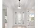 Bright and modern foyer with a beautiful glass front door, decorative glass and transom, and white walls at 8465 Sw 101St Ave, Ocala, FL 34481