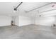 Spacious garage with concrete floor and overhead door tracks, providing ample parking and storage at 8465 Sw 101St Ave, Ocala, FL 34481