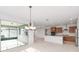 Open kitchen and dining area with stainless steel appliances and sliding glass doors at 8465 Sw 101St Ave, Ocala, FL 34481
