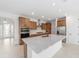 Gourmet kitchen featuring quartz countertops, stainless steel appliances, and wooden cabinets at 8465 Sw 101St Ave, Ocala, FL 34481