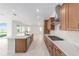 Bright, modern kitchen open to the living area with stone countertops and stainless appliances at 8465 Sw 101St Ave, Ocala, FL 34481