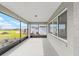 Covered lanai with screened openings, offering outdoor living space with views of the backyard at 8465 Sw 101St Ave, Ocala, FL 34481