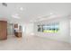 Open concept living room with kitchen island and large windows offering natural light at 8465 Sw 101St Ave, Ocala, FL 34481
