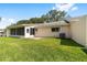 Backyard features screened-in lanai, mature trees, and lush green grass at 8998 Sw 94Th St # D, Ocala, FL 34481