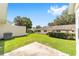 Large backyard features patio, lush green grass, privacy hedges and mature trees at 8998 Sw 94Th St # D, Ocala, FL 34481