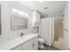 Updated bathroom with modern vanity, marble countertop, shower-tub combo, and tiled floor at 8998 Sw 94Th St # D, Ocala, FL 34481