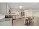 Modern kitchen features stainless steel appliances, granite countertops, and a convenient island with seating at 8998 Sw 94Th St # D, Ocala, FL 34481