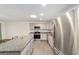 Open concept kitchen features stainless appliances, granite countertops, and a breakfast bar island at 8998 Sw 94Th St # D, Ocala, FL 34481