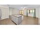Open concept design with gray cabinets, granite island, and dining area with natural light at 8998 Sw 94Th St # D, Ocala, FL 34481